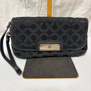 Black clutch wristlet, likely featuring silver-tone hardware